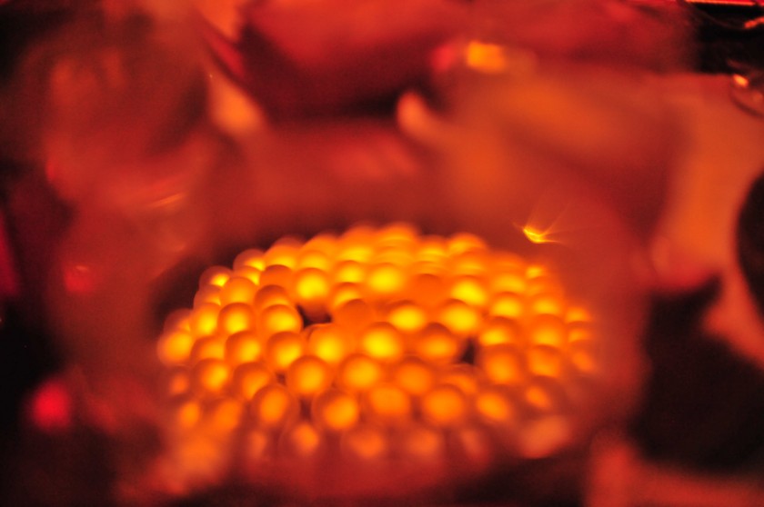 Lights reflected in wine glass.