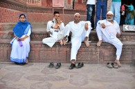 A Christian, a Muslim, and a Hindu all sitting in a row.